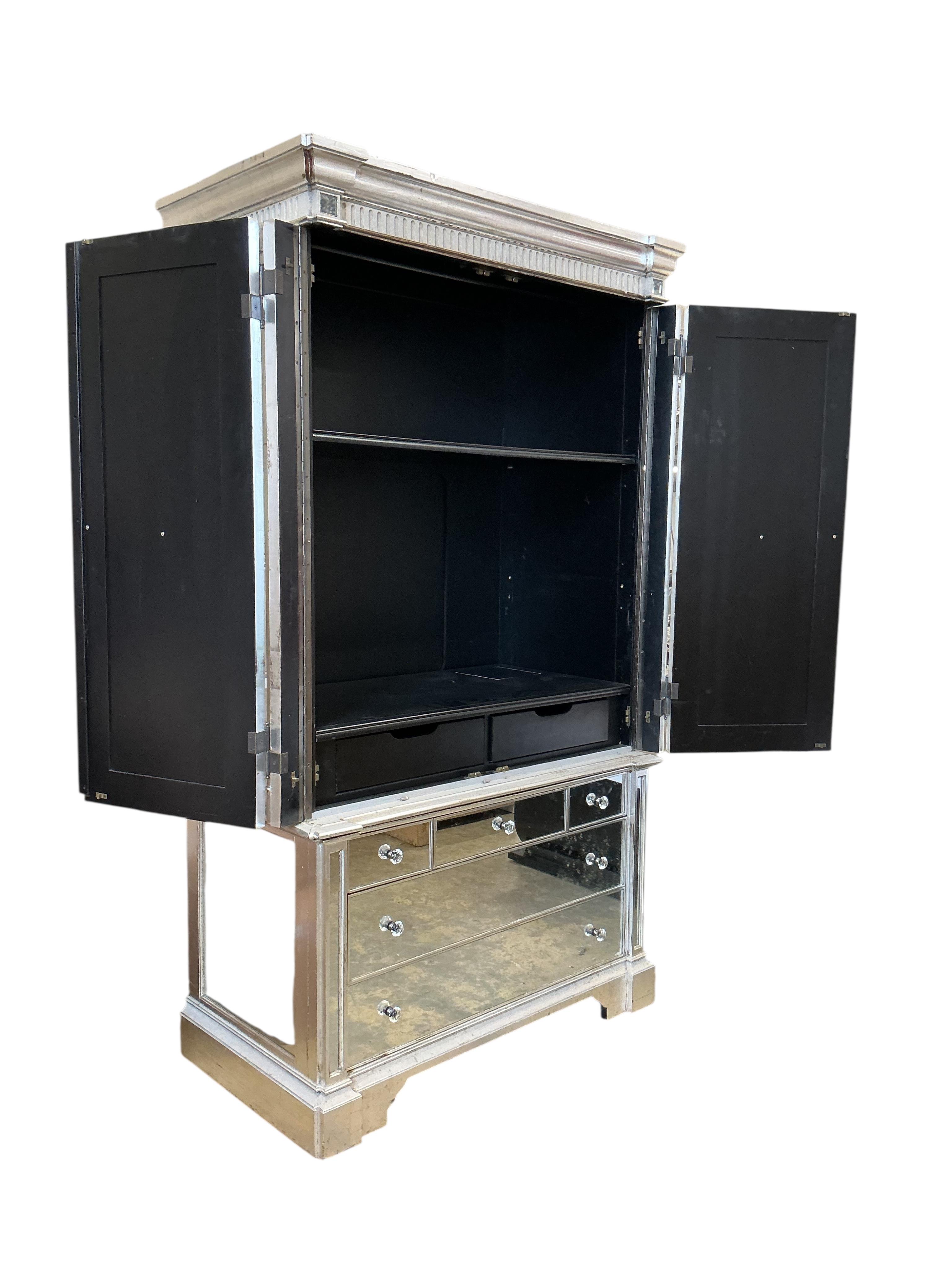 A contemporary mirrored media cabinet, width 144cm, depth 67cm, height 22cm
